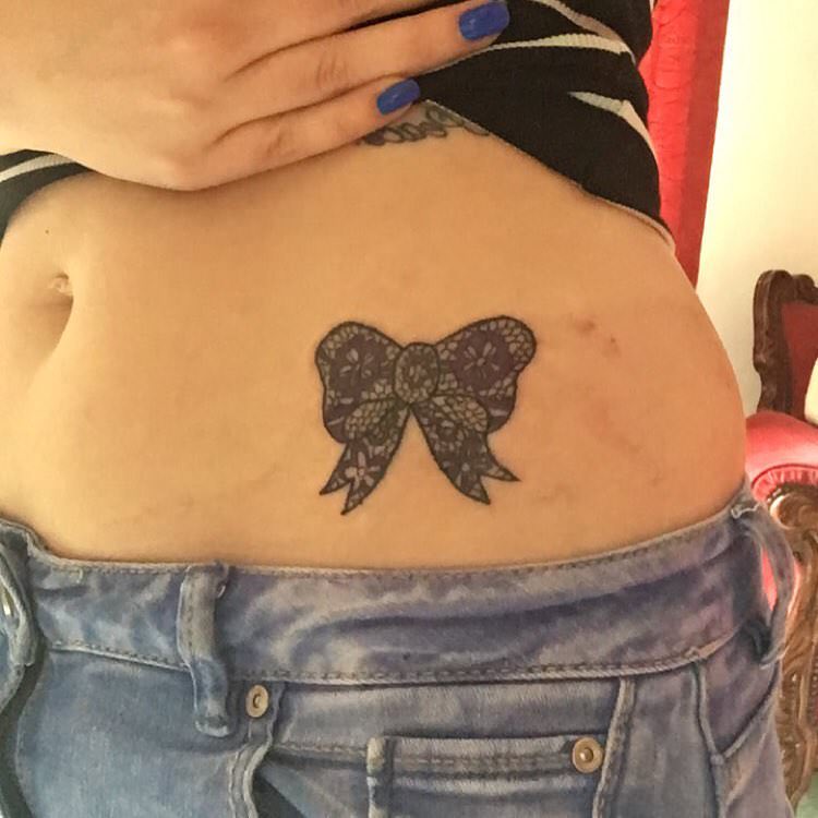 Classic Black Ink Bow Tattoo On Girl Left Hip
