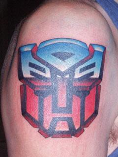 Colorful Transformer Logo Tattoo On Right Shoulder By Wesley