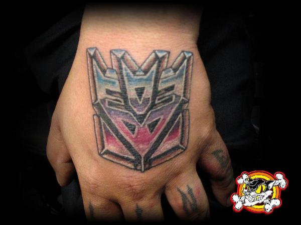 Cool Transformer Logo Tattoo On Hand