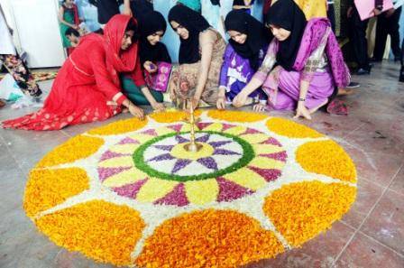 Girls Decorating Rangoli During Onam Celebrations