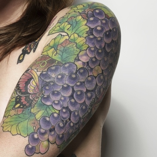 Grapes With Butterfly Tattoo On Girl Left Half Sleeve