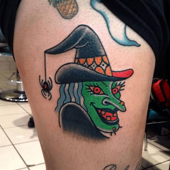 Green Ink Witch Face Tattoo On Side Thigh