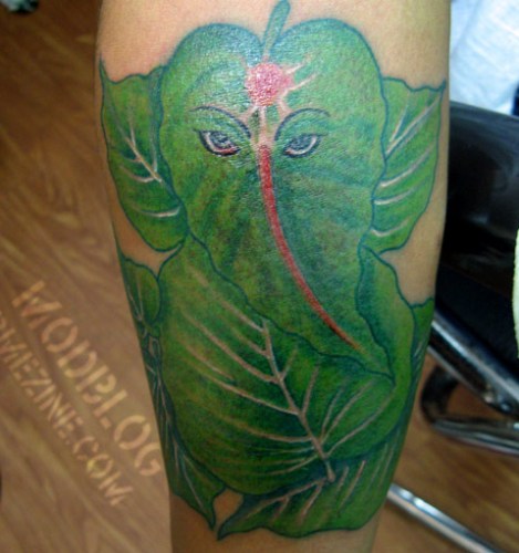 Green Peepal Leafs Ganesha Tattoo On Arm