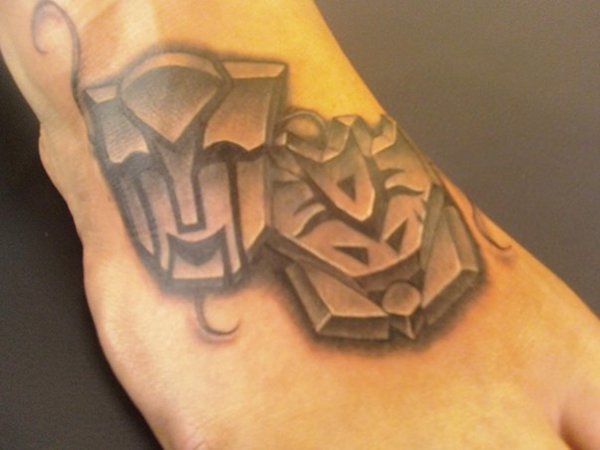 Grey Ink 3D Two Transformer Symbol Tattoo On Right Foot