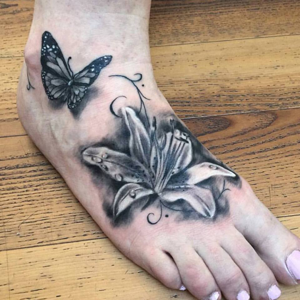 Grey Ink Flower And Butterfly Tattoo On Right Foot by Kat