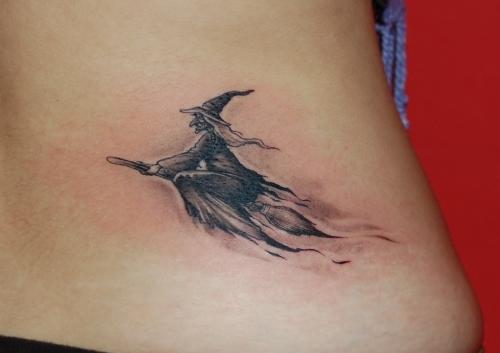 Grey Ink Flying Witch Tattoo On Girl Lower Back