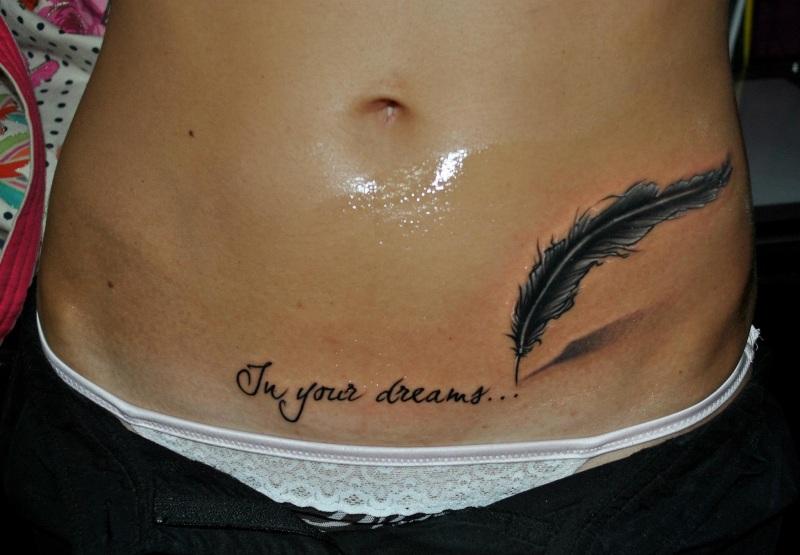 In Your Dreams - Black Ink Feather Tattoo On Girl Hip
