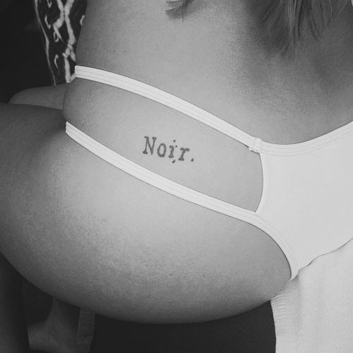 Noir Word Tattoo On Girl Left Hip