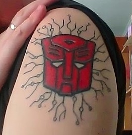 Red Ink Transformer Tattoo On Left Shoulder