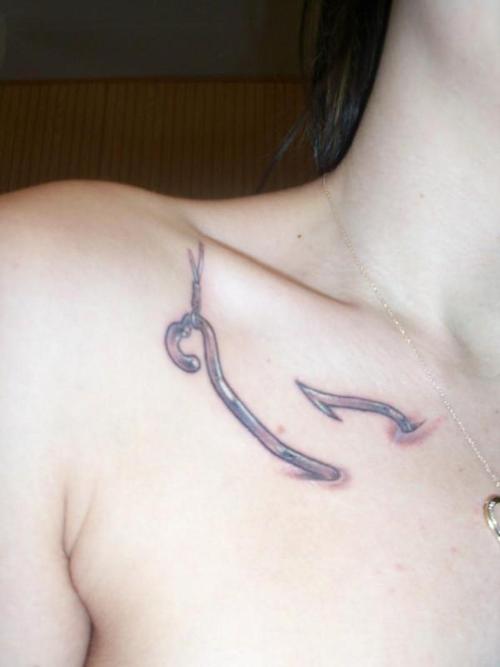 Ripped Skin Hook Tattoo On Girl Collar Bone