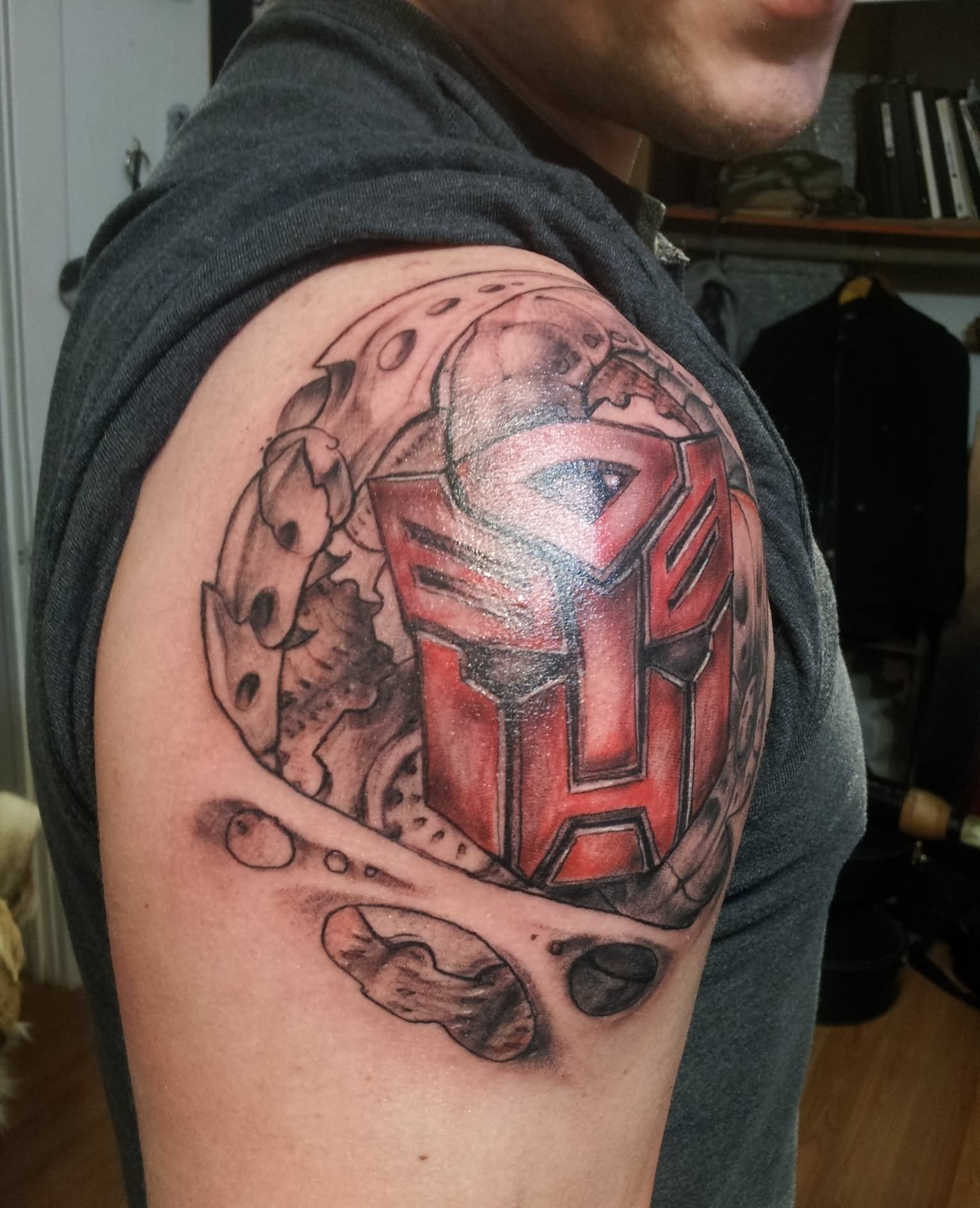 Ripped Skin Transformer Logo Tattoo On Man Right Shoulder