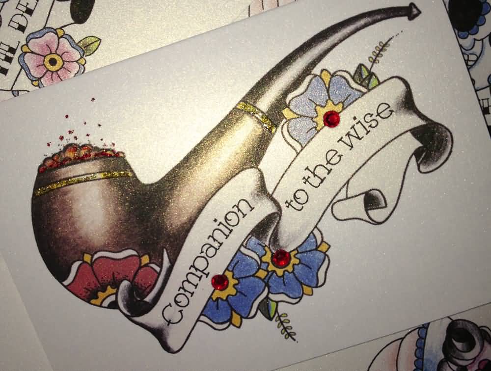 Traditional Pipe With Flowers And Banner Tattoo Design