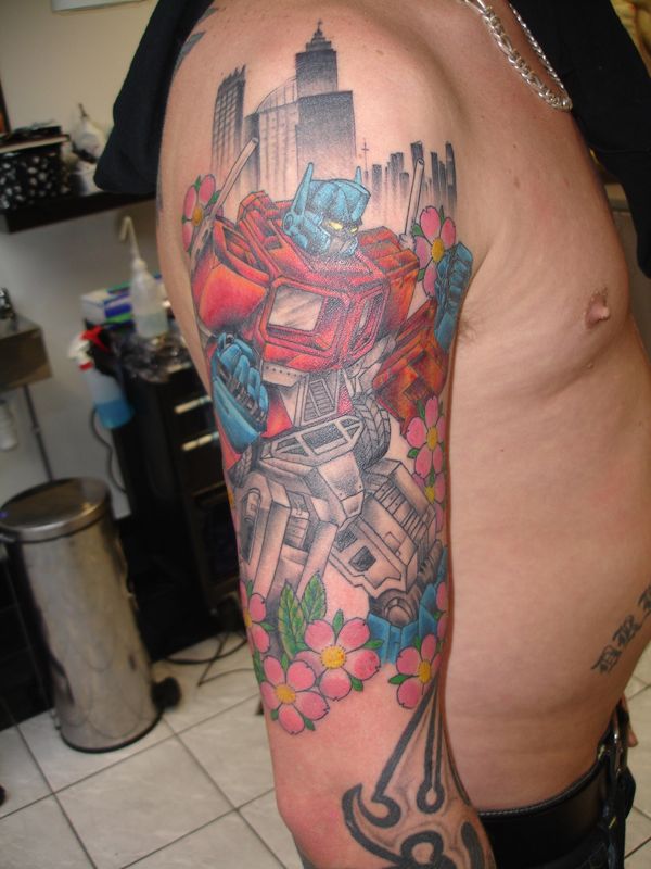 Transformer Starscream With Cherry Blossom Flowers Tattoo On Man Right Half Sleeve By