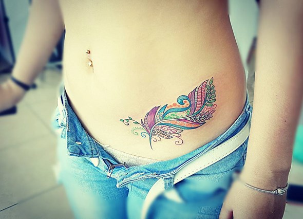 Unique Colorful Feather Tattoo On Girl Left Hip