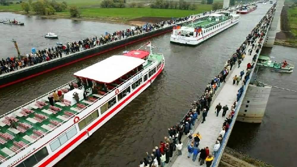 Visitors Watching The Ships Passing From The Magdeburg Water Bridge In Germany