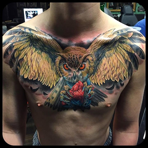 Wicked Owl With Heart In Claws Tattoo On Man Chest