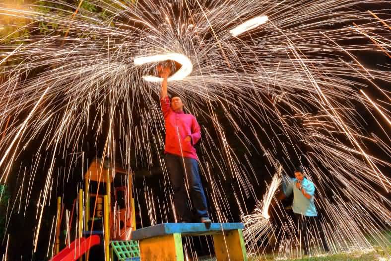 A Muslim Man Use A Soft Brush To Produce Fireworks Ahead Of Eid Al-Adha Celebrations