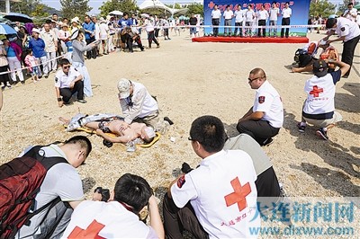 A Rescuer Performs CPR On A Drowned Tourist On A Beach During An Emergency Rescue Drill Held In Dalian City On World First Aid Day