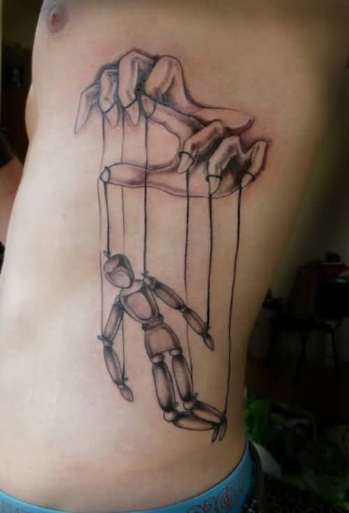 Black And Grey Marionette Doll Tattoo On Man Left Side Rib