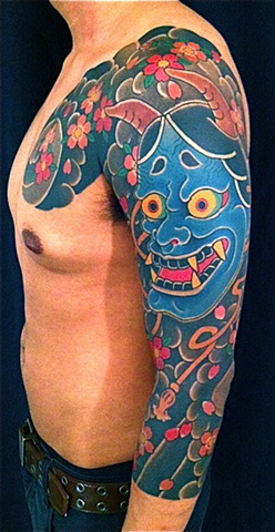 Blue Ink Hannya Mask Tattoo On Left Sleeve