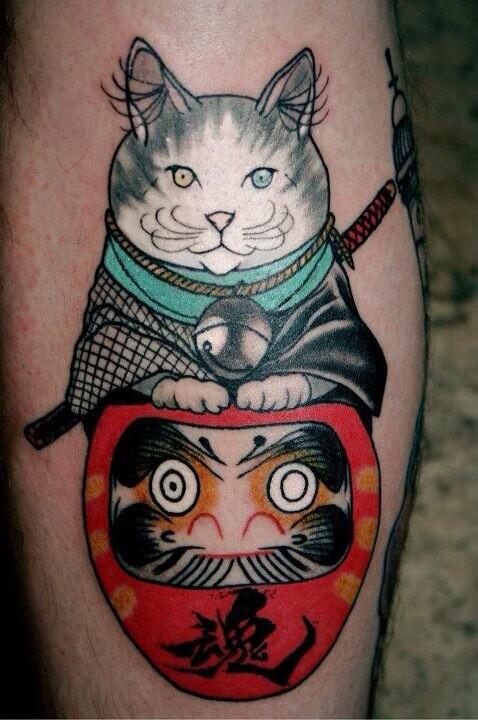 Cool Daruma Doll With Cat Tattoo Design For Leg By Lewis Buckley