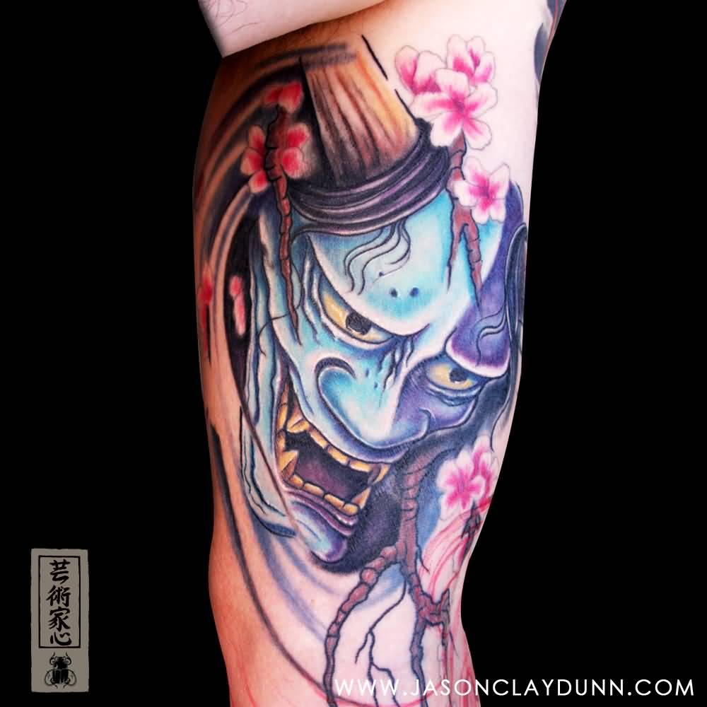 Pink Flowers And Hannya Mask Tattoo On Bicep