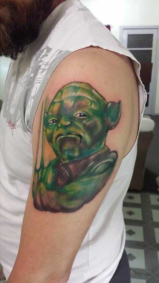 Unique Yoda Tattoo On Man Left Half Sleeve