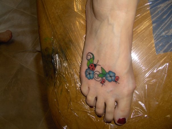 Beautiful Blue Flowers And Ladybug Tattoo On Right Foot
