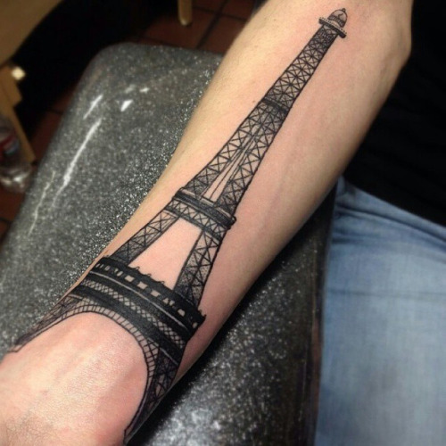 Black And Grey Eiffel Tower Tattoo On Forearm