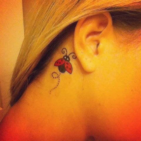 Black And Red Ladybug Tattoo Behind The Ear