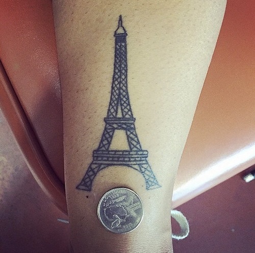 Black Ink Small Eiffel Tower Tattoo On Leg