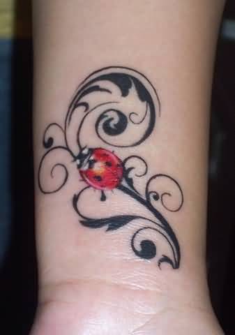 Black Tribal And Red Ladybug Tattoo On Wrist