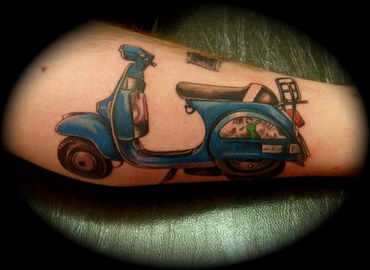 Blue Ink Scooter Tattoo On Arm