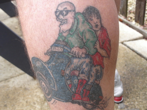 Colored Scooter Tattoo On Left Leg