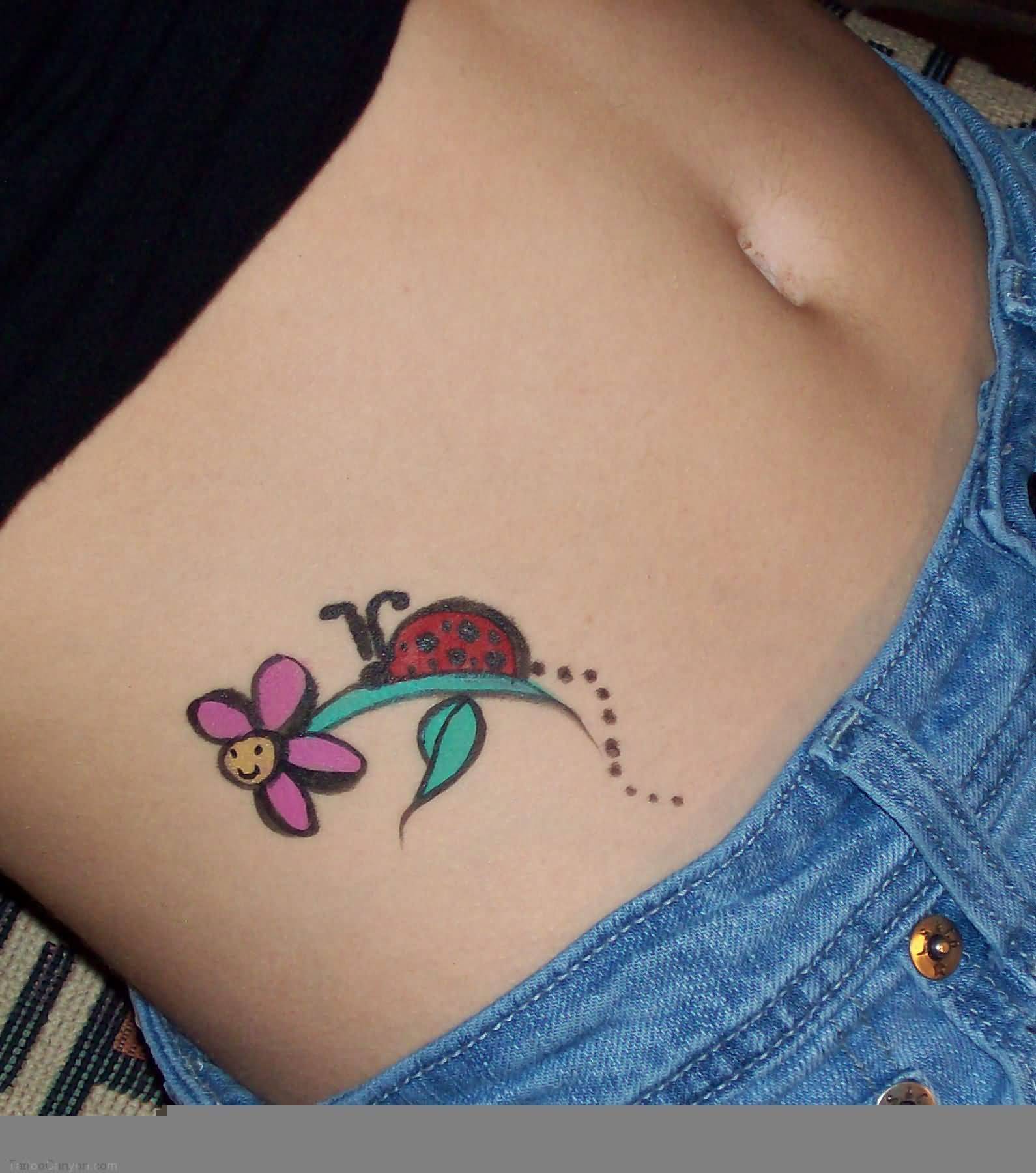 Flower And Ladybug Tattoo On Hip