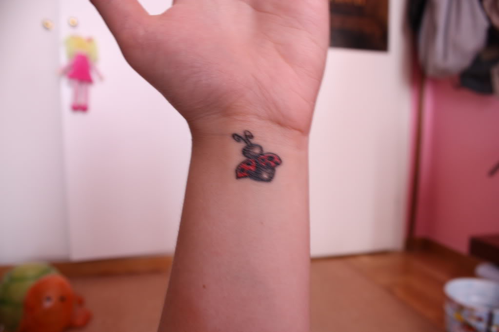 Flying Ladybug Tattoo On Left Wrist