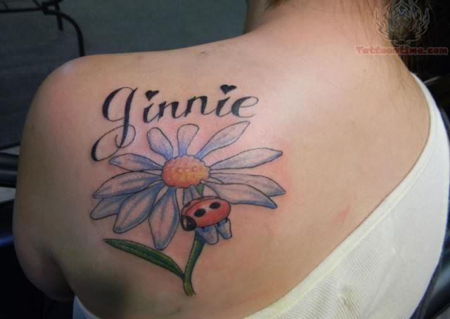 Ginnie Name And Ladybug With Daisy Flower Tattoo On Back Shoulder