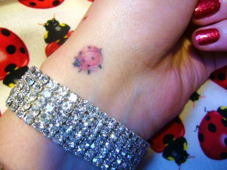 Girl Have Ladybug Tattoo On Left Wrist