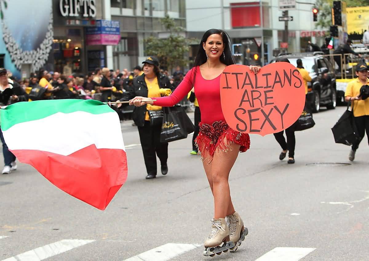 Girl With Italians Are Sexy Banner And Italian Flag During Columbus Day Parade