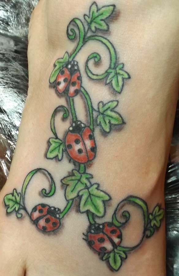 Green Ivy Flowers And Ladybug Tattoo On Right Foot