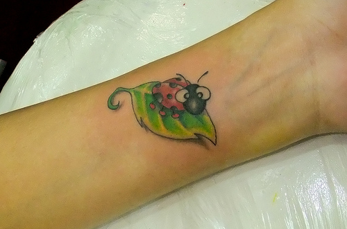 Green Leaf And Ladybug Animated Tattoo On Wrist