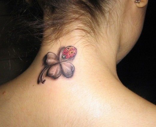Grey Four Leaf And Ladybug Tattoo On Nape