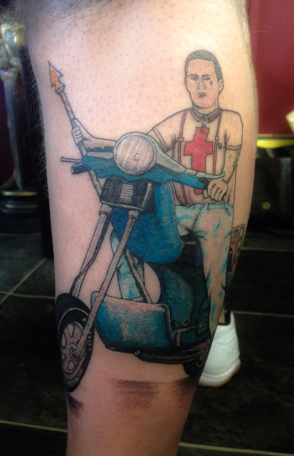 Guy Riding Rumy Scooter Tattoo On Leg