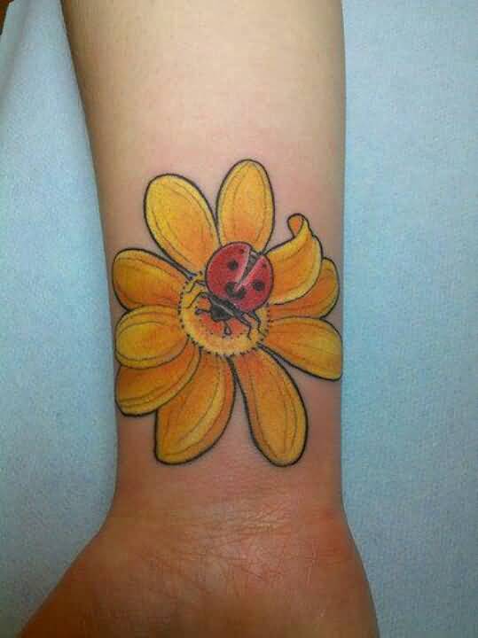 Ladybug On Yellow Flower Tattoo On Wrist