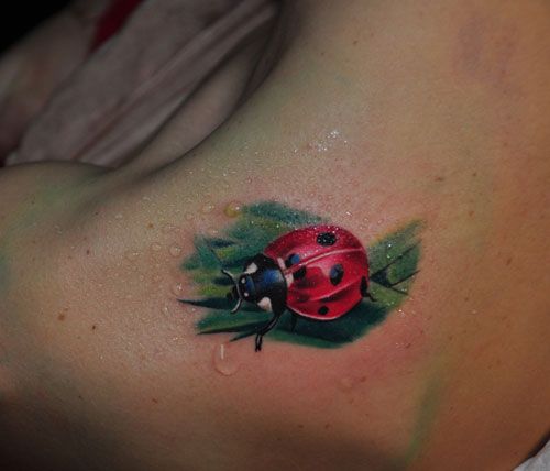 Ladybug Tattoo On Upper Back