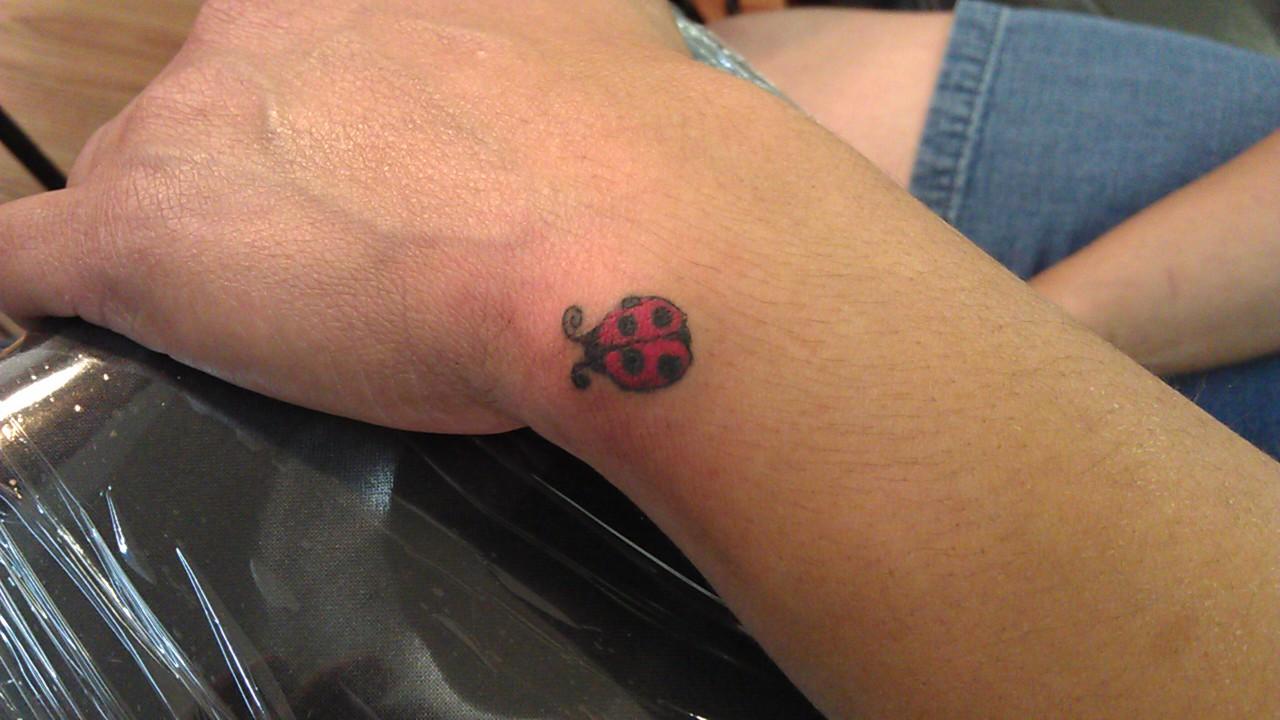 Little Ladybug Tattoo On Upper Wrist