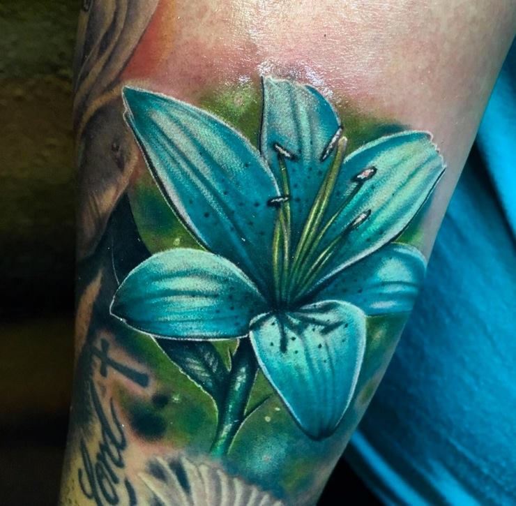 Nice Blue Lily Flower Tattoo On Arm