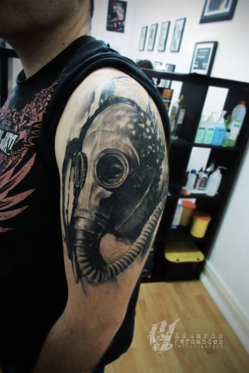 Nice Gas Mask Tattoo On Man Left Shoulder