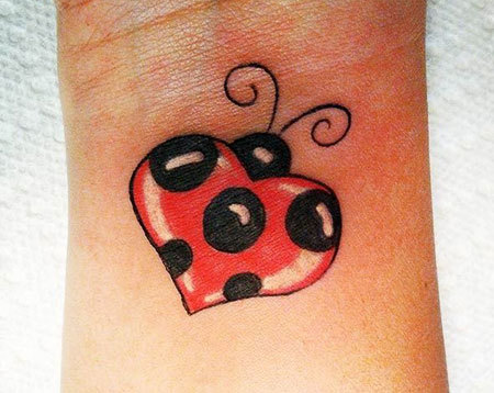 Nice Heart Shape Ladybug Tattoo On Wrist