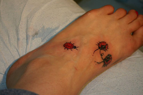 Nice Three Ladybug Tattoos On Left Foot